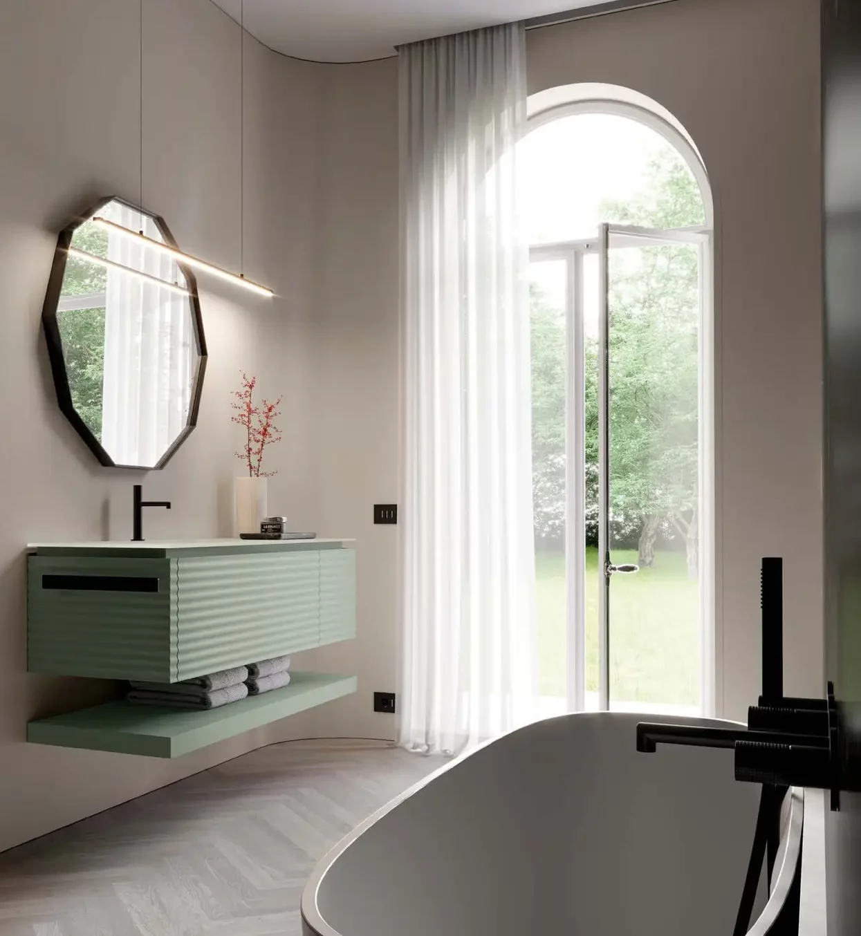 Salle de bain moderne haut de gamme avec un meuble-lavabo flottant vert menthe, un miroir ovale, des luminaires noirs, une baignoire autoportante et une grande fenêtre cintrée avec des rideaux diaphanes donnant sur une cour verdoyante.